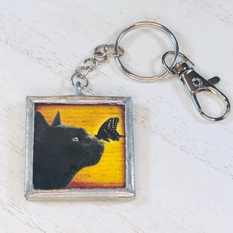 Handmade Glass and Silver Soldered Reversible Keychain - Lead Free Pewter Finish - Black Cat with Butterfly - jennrossdesigns.com